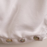 Pelele bebé piqué blanco punto celeste